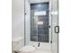 Bathroom showcasing a glass enclosed shower and decorative gray subway tile at 532 Rockbridge Rd, Lilburn, GA 30047
