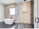 Modern bathroom with a soaking tub, glass-enclosed shower, and sleek tile at 532 Rockbridge Rd, Lilburn, GA 30047