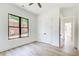 Light-filled bedroom with plank floors, a modern closet and large window providing natural light at 532 Rockbridge Rd, Lilburn, GA 30047