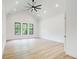 Bright bedroom with high ceilings, large windows, and light wood flooring at 532 Rockbridge Rd, Lilburn, GA 30047