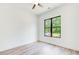 Bright bedroom with a large window offering views of the outdoors and ceiling fan at 532 Rockbridge Rd, Lilburn, GA 30047