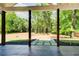 Covered patio with stone flooring and views of the expansive backyard at 532 Rockbridge Rd, Lilburn, GA 30047