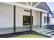 Exterior patio with stone flooring and a well-manicured lawn leading to the house at 532 Rockbridge Rd, Lilburn, GA 30047