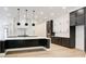 Spacious kitchen showcasing a waterfall island, stainless appliances, and custom black and white cabinetry at 532 Rockbridge Rd, Lilburn, GA 30047
