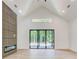 Bright living room featuring vaulted ceilings, fireplace, and sliding glass doors to the backyard at 532 Rockbridge Rd, Lilburn, GA 30047
