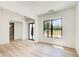 Open-concept living room features a large window, glass door, and light hardwood floors at 532 Rockbridge Rd, Lilburn, GA 30047