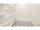 Pantry area with lots of shelves and black and white patterned floors at 532 Rockbridge Rd, Lilburn, GA 30047