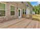 Wood deck, perfect for outdoor entertaining with beautiful brick and door access to the home at 297 Delta Dr, Mcdonough, GA 30252