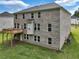 Exterior view of backyard with brick, deck, and a manicured lawn perfect for entertaining at 297 Delta Dr, Mcdonough, GA 30252
