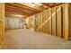 Large unfinished basement with concrete floors and framed walls, offering potential for expansion at 297 Delta Dr, Mcdonough, GA 30252
