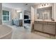 Main bathroom featuring dual vanities, a soaking tub, and tiled flooring with plenty of light at 297 Delta Dr, Mcdonough, GA 30252