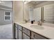 Bathroom featuring double vanity with light countertop, grey cabinetry, and modern fixtures at 297 Delta Dr, Mcdonough, GA 30252