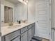 Bathroom featuring double vanity with light countertop, grey cabinetry, and modern fixtures at 297 Delta Dr, Mcdonough, GA 30252