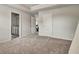 Carpeted bedroom with neutral color scheme and closet, plus a door to the bathroom at 297 Delta Dr, Mcdonough, GA 30252