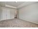 Carpeted bedroom with neutral color scheme and closet, plus a door to the hallway at 297 Delta Dr, Mcdonough, GA 30252