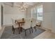 Bright dining room features modern chandelier, decorative rug and wainscoting at 297 Delta Dr, Mcdonough, GA 30252