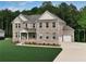 Stunning two-story brick home with attached two-car garage, well-manicured lawn and welcoming front porch at 297 Delta Dr, Mcdonough, GA 30252