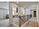 Upstairs hallway overlooking staircase with iron spindles and wooden handrail at 297 Delta Dr, Mcdonough, GA 30252