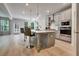 Modern kitchen with stainless steel appliances, island with seating, and wood floors at 297 Delta Dr, Mcdonough, GA 30252