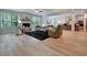Open concept living room with fireplace, wood floors, and large windows at 297 Delta Dr, Mcdonough, GA 30252
