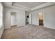 Bright main bedroom features a walk-in closet and attached bathroom with neutral carpeting at 297 Delta Dr, Mcdonough, GA 30252