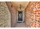 Charming entryway with brick walls, hanging light fixture, black door, and 'WELCOME' sign at 506 Glen Ivy # 5, Marietta, GA 30062