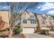 Inviting townhouse with a two-car garage, a combination of brick and siding, and a neatly manicured front yard at 506 Glen Ivy # 5, Marietta, GA 30062