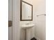 Modern powder room with a pedestal sink, decorative mirror, and stylish fixtures at 668 Isom Walk, Suwanee, GA 30024