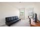 Simple bedroom with a couch, desk, and two windows, offering lots of natural light at 668 Isom Walk, Suwanee, GA 30024