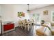 Cozy dining area with a wooden table, pendant light, and adjacent to the living room at 668 Isom Walk, Suwanee, GA 30024
