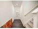 Modern entryway with stylish wood floors, white walls, and staircase with carpeted steps at 668 Isom Walk, Suwanee, GA 30024