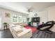 Bright living room with a large sofa, ceiling fan, and hardwood flooring at 668 Isom Walk, Suwanee, GA 30024