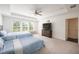 Spacious bedroom with two beds, tray ceiling, and large windows offering plenty of natural light at 668 Isom Walk, Suwanee, GA 30024