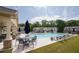 Community pool with ample seating, umbrellas, and well-maintained landscaping for a relaxing outdoor experience at 668 Isom Walk, Suwanee, GA 30024