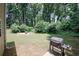 Large backyard featuring mature trees, a patio, a grill, and ample room for outdoor activities at 1000 Willow Crest Lndg, Austell, GA 30168