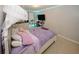 Cozy bedroom with purple bedding, a mounted TV, and a comfortable study area with plenty of natural light at 1000 Willow Crest Lndg, Austell, GA 30168