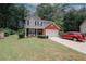 Charming home exterior with a well-manicured lawn, brick accents, and a two-car garage at 1000 Willow Crest Lndg, Austell, GA 30168