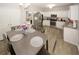 Cozy dining area near kitchen with table for six, stainless steel refrigerator, and white cabinetry at 1000 Willow Crest Lndg, Austell, GA 30168