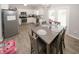 Eat-in kitchen featuring stainless steel appliances, white cabinets and modern gray dining table at 1000 Willow Crest Lndg, Austell, GA 30168