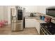 Bright kitchen featuring a stainless steel refrigerator, white cabinets, and stylish countertops at 1000 Willow Crest Lndg, Austell, GA 30168