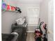 Well-organized laundry room with washer and dryer, a window, shelving, and cleaning supplies at 1000 Willow Crest Lndg, Austell, GA 30168