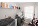 Functional laundry room featuring modern washer, dryer and storage shelving at 1000 Willow Crest Lndg, Austell, GA 30168
