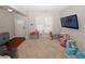 Bright living room with a front door, a window, TV, toys, gray walls and carpet floors at 1000 Willow Crest Lndg, Austell, GA 30168