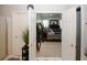 Open view of a main bedroom with a large bed and dresser through a doorway with double doors at 1000 Willow Crest Lndg, Austell, GA 30168