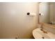 Neat powder room featuring a framed mirror, a white sink, and modern fixtures at 1000 Willow Crest Lndg, Austell, GA 30168