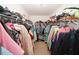 Spacious walk-in closet with plentiful storage solutions including shelving and hanging racks for clothes and shoes at 1000 Willow Crest Lndg, Austell, GA 30168