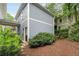 Serene backyard featuring a covered patio, wood siding, and a lush privacy hedge at 1020 Austin Ne Ave, Atlanta, GA 30307