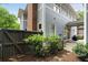 Backyard with an attractive patio, a grill, mature shrubs, a chimney and a dark wooden fence at 1020 Austin Ne Ave, Atlanta, GA 30307
