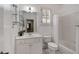 Bright bathroom featuring a tub/shower combo, glass shelving, and white vanity with countertop at 1020 Austin Ne Ave, Atlanta, GA 30307