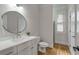 Bright bathroom with a modern vanity, round mirror, and glass shower at 1020 Austin Ne Ave, Atlanta, GA 30307